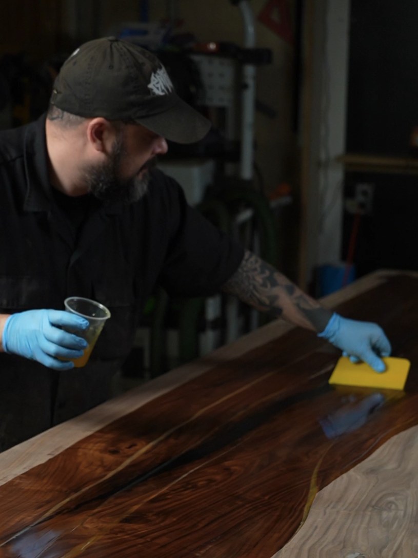 Daniel Rodriguez working finish into a walnut table top