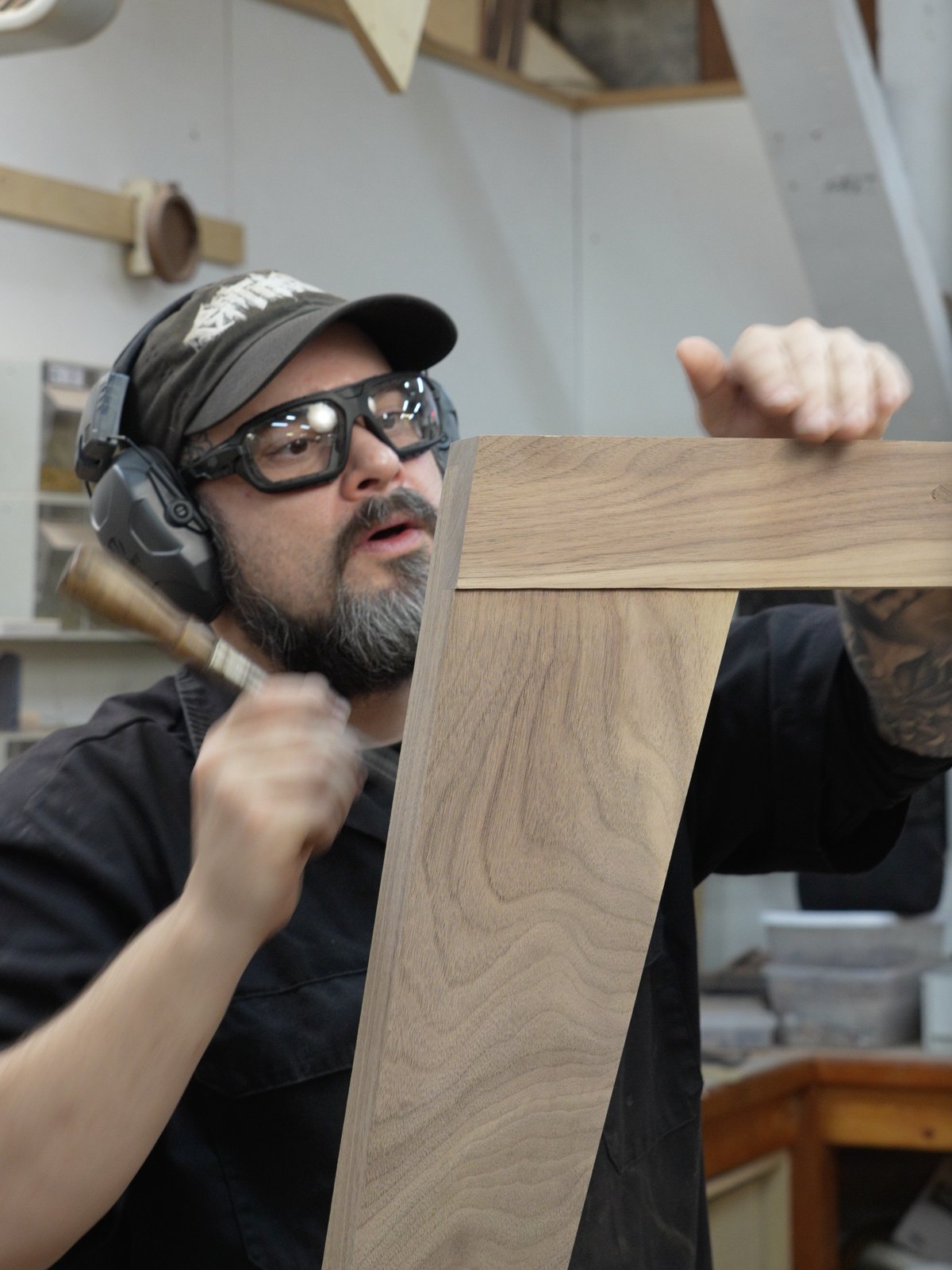 Daniel Rodriguez paring a joint on a walnut table base with a chisel