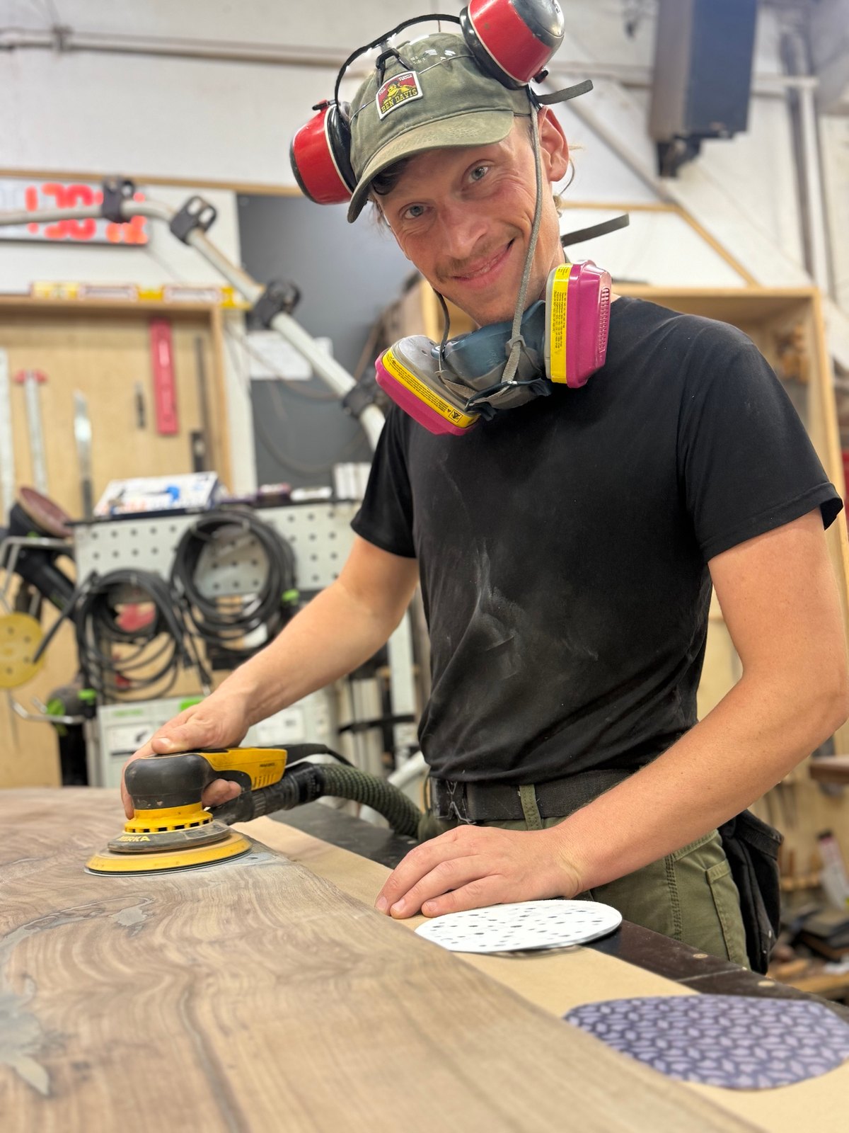 Devon Carsen sanding a walnut table top