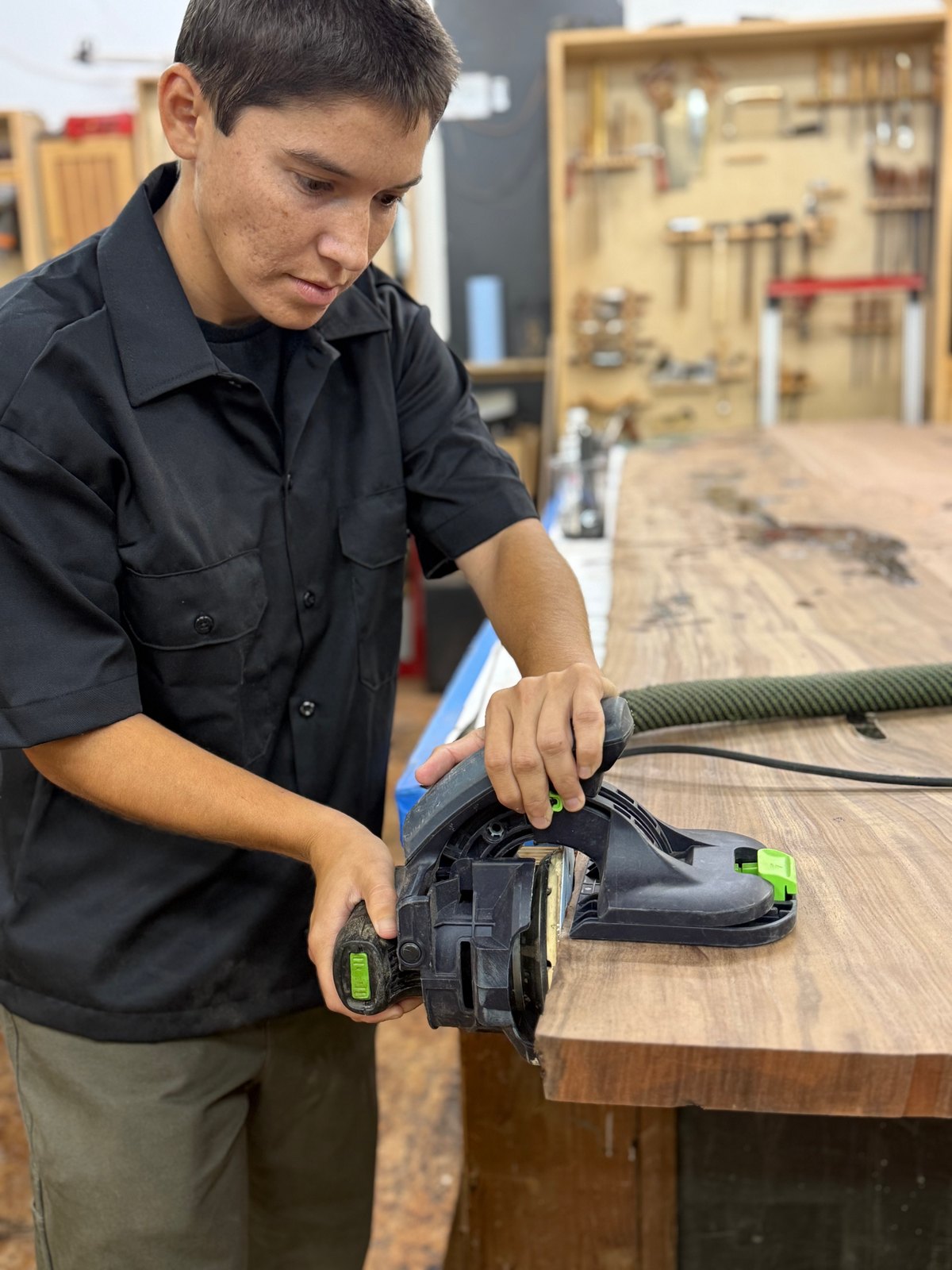 Jade Gregory working the edge of a walnut slab