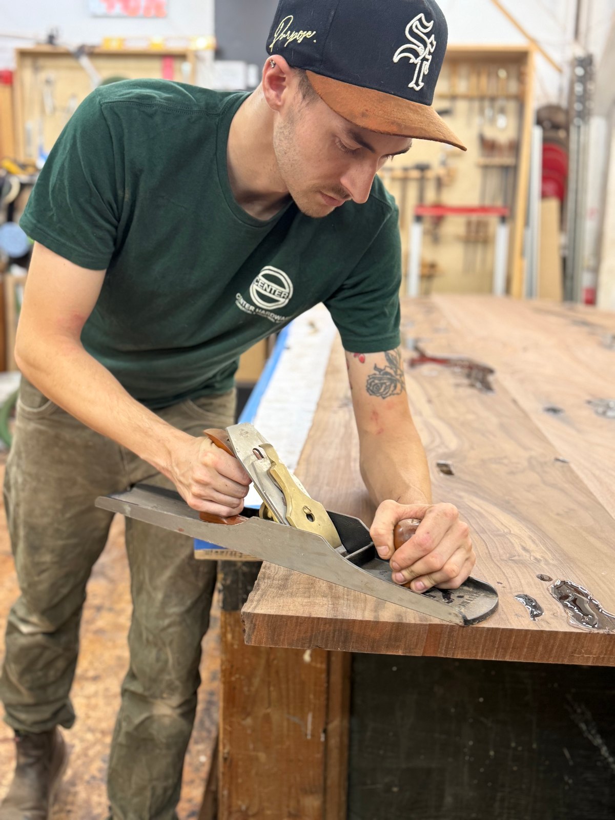 John McGuire hand planing the edge of a slab table top